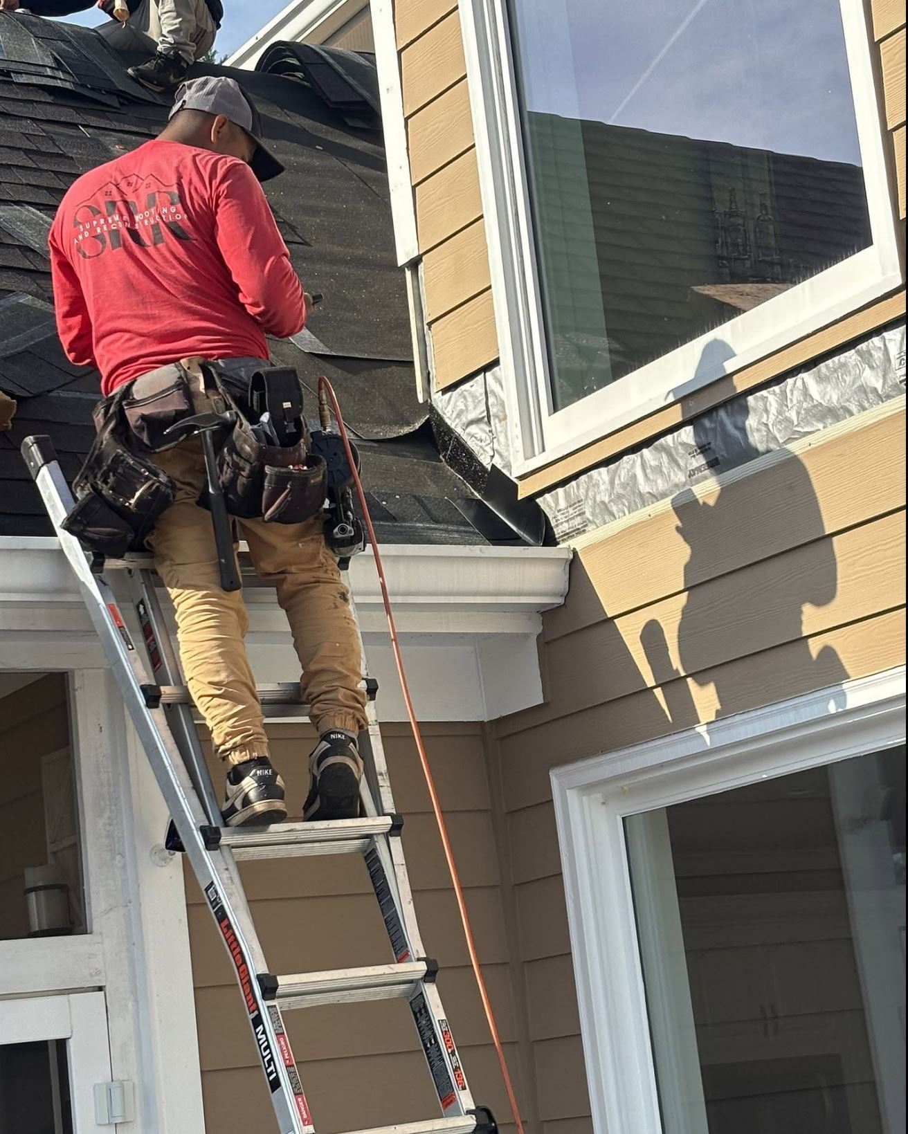 Supreme Roofing crew installing gutters in Marietta, Cobb County GA